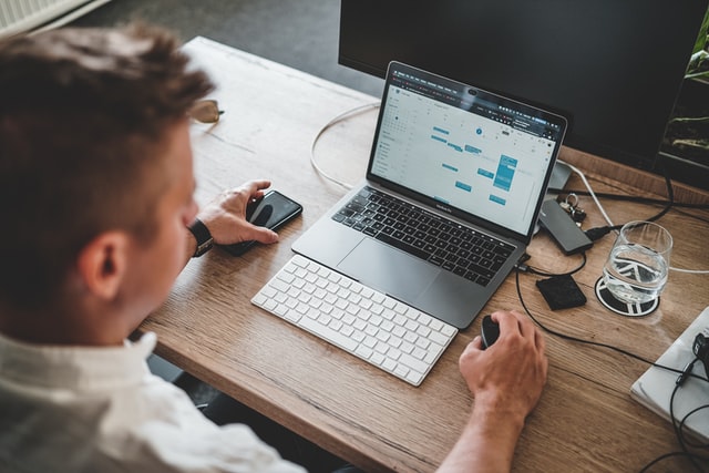 man using calendar app on laptop